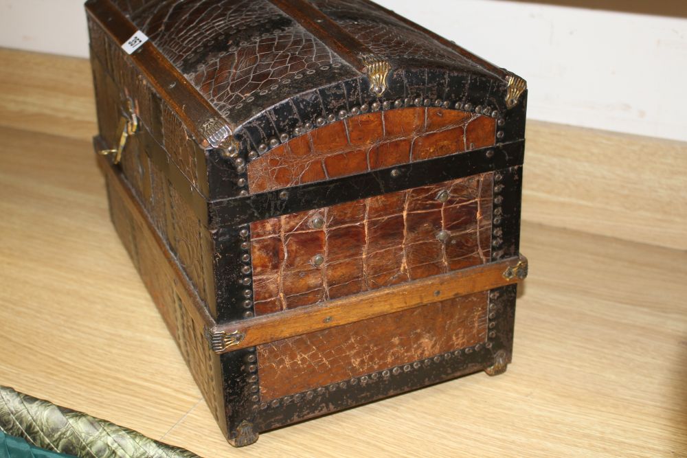 An early 20th century iron and wood bound crocodile covered miniature cabin trunk, with brass latch, length 46cm, height 31.5cm, depth
